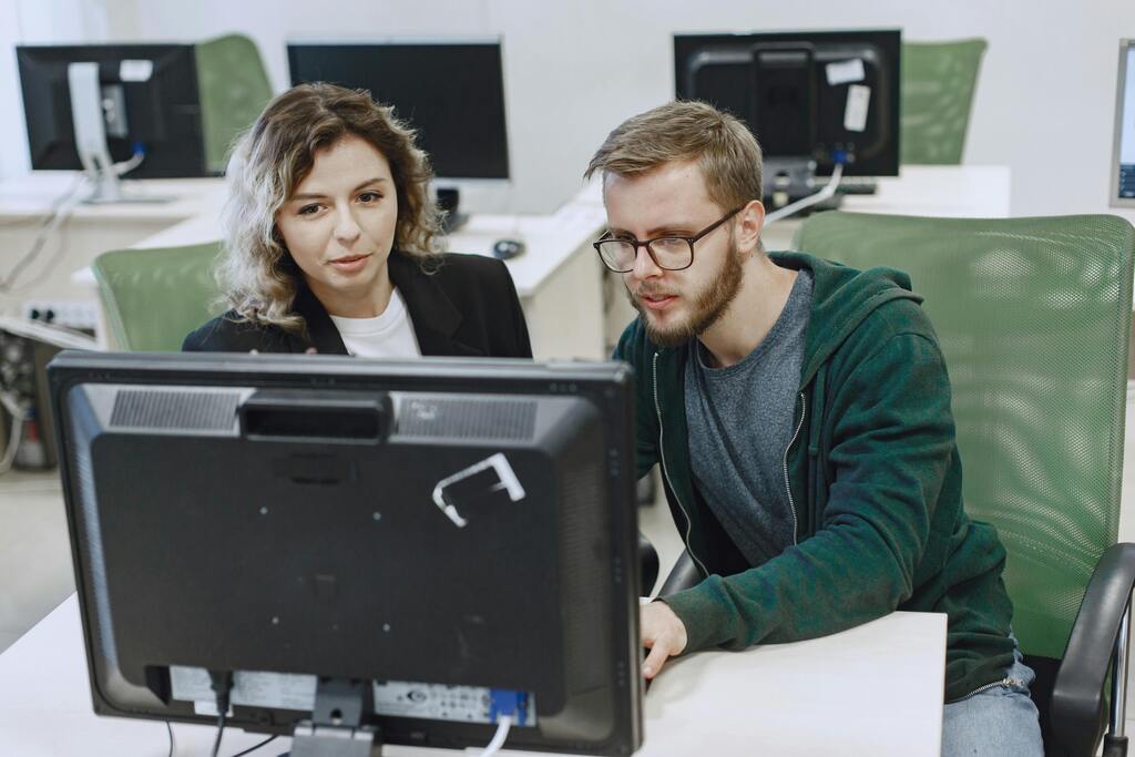 two people looking at a computer design of a lazy susan and discussing  the high quality of it.